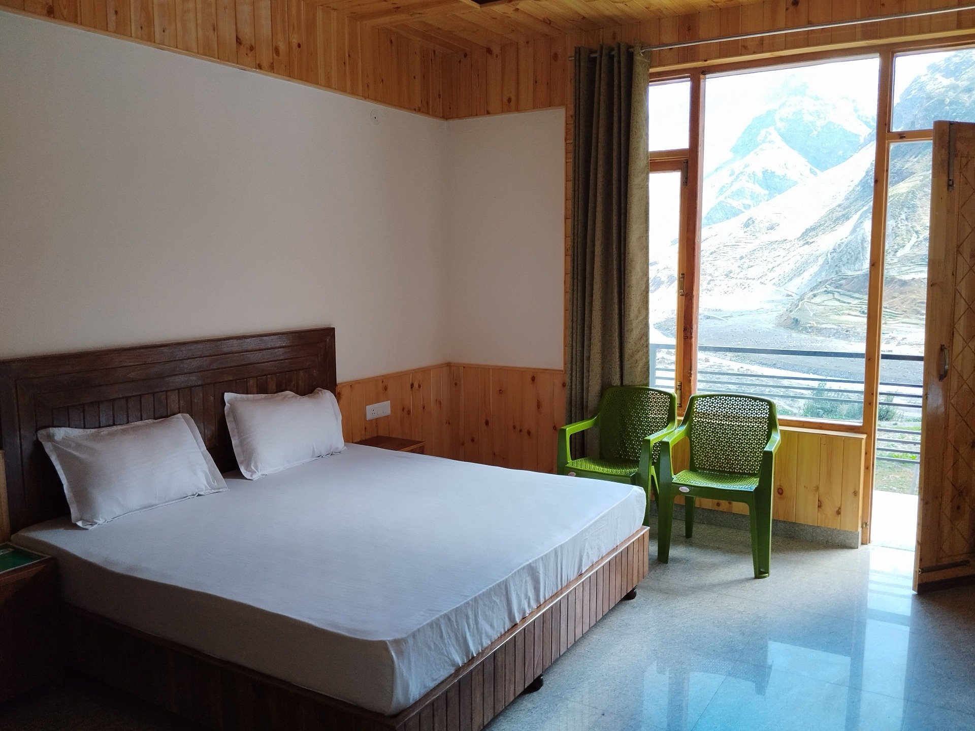 Spacious Family Suite at Juniper Tree featuring private balcony views of snow-covered mountains in Sissu.