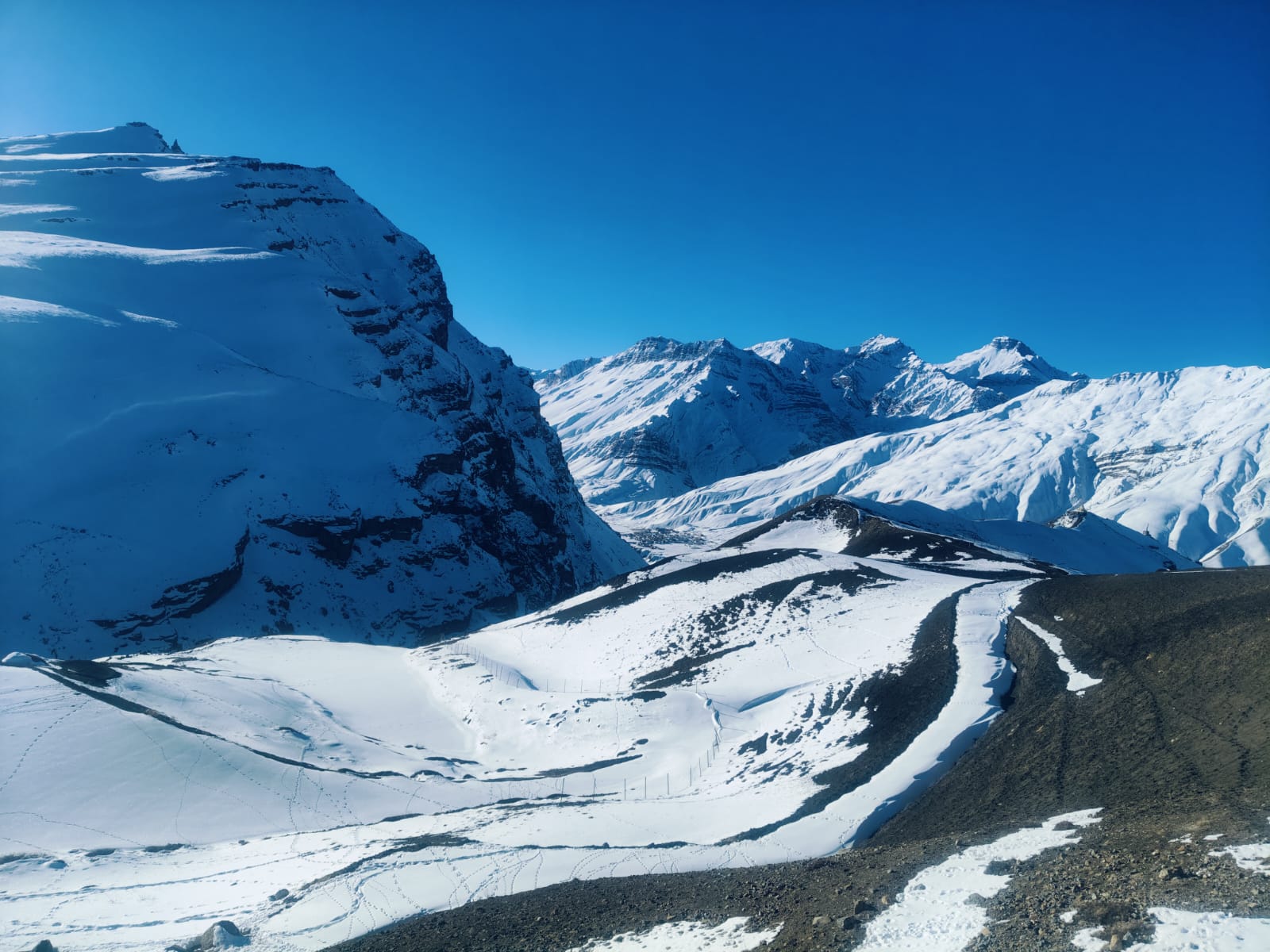 Snow-capped Himalayan peaks towering over the high-altitude terrain.