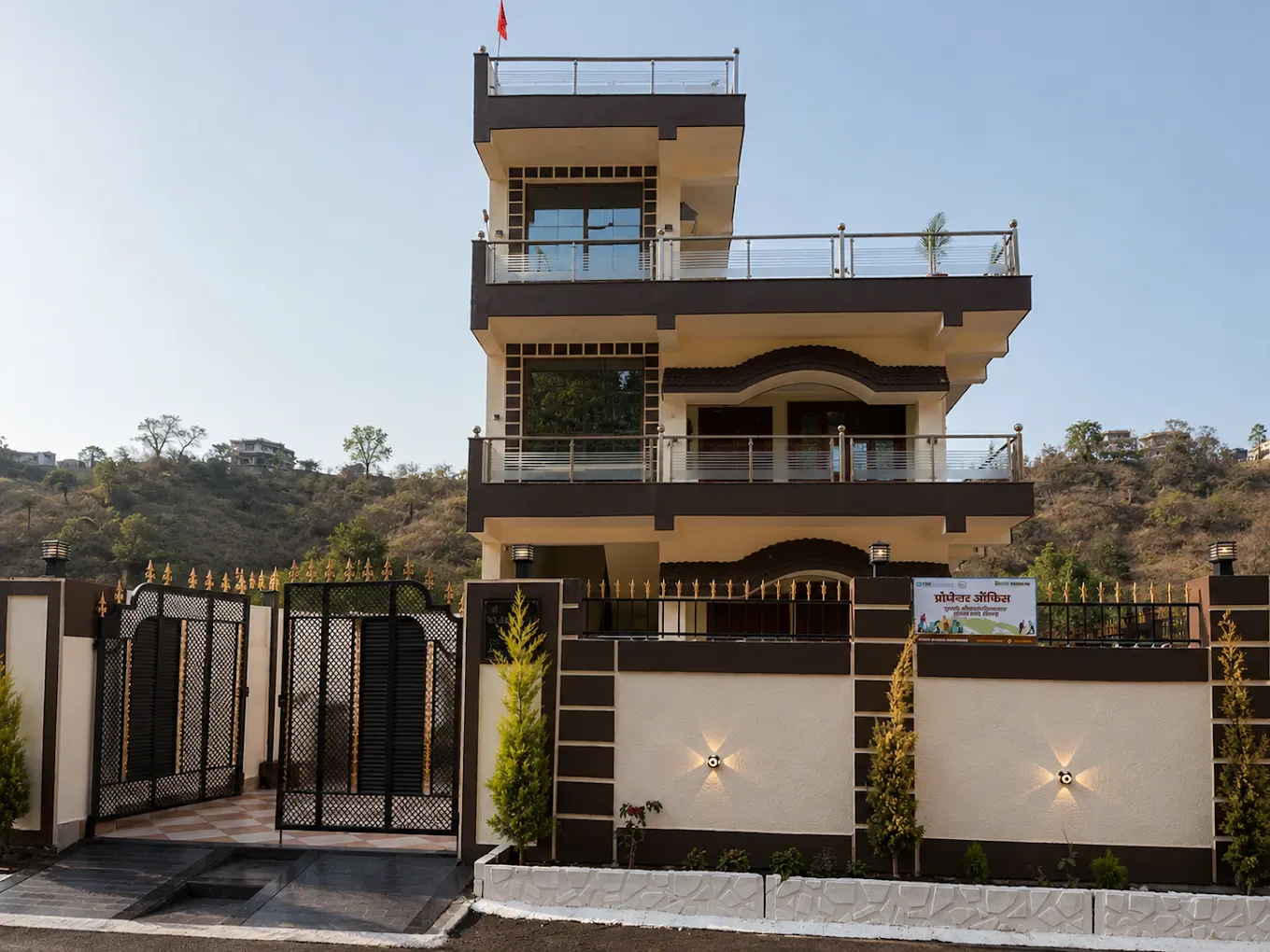 Front view of White Wood Home Stay featuring modern architecture, private balconies, and scenic mountain backdrops