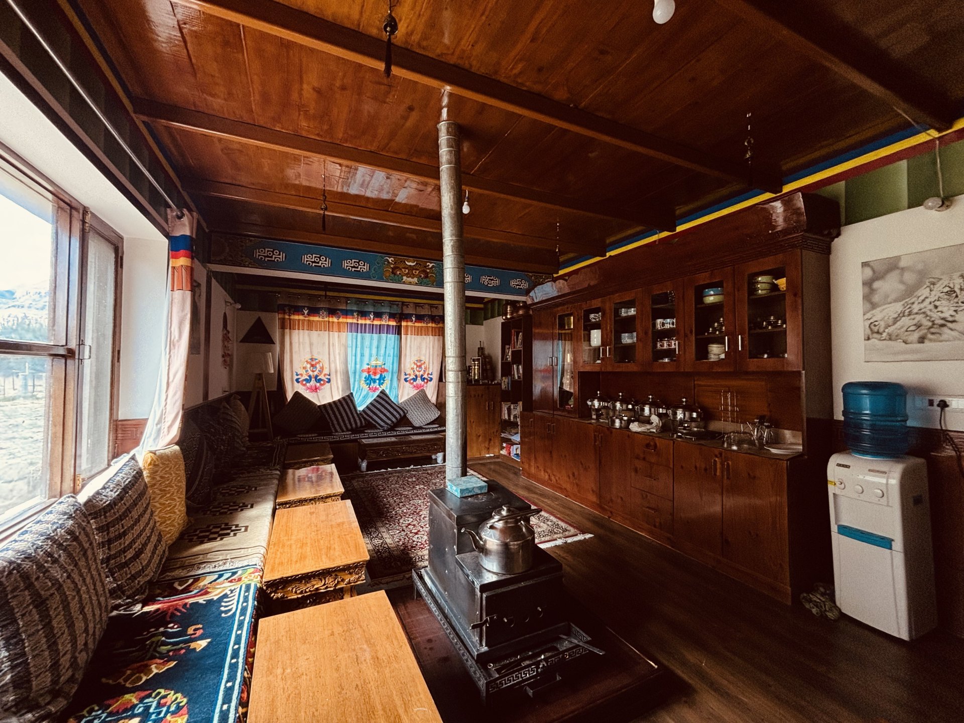 Traditional Spitian kitchen and seating area with a classic wood-burning stove at White Lotus Homes in Tabo.