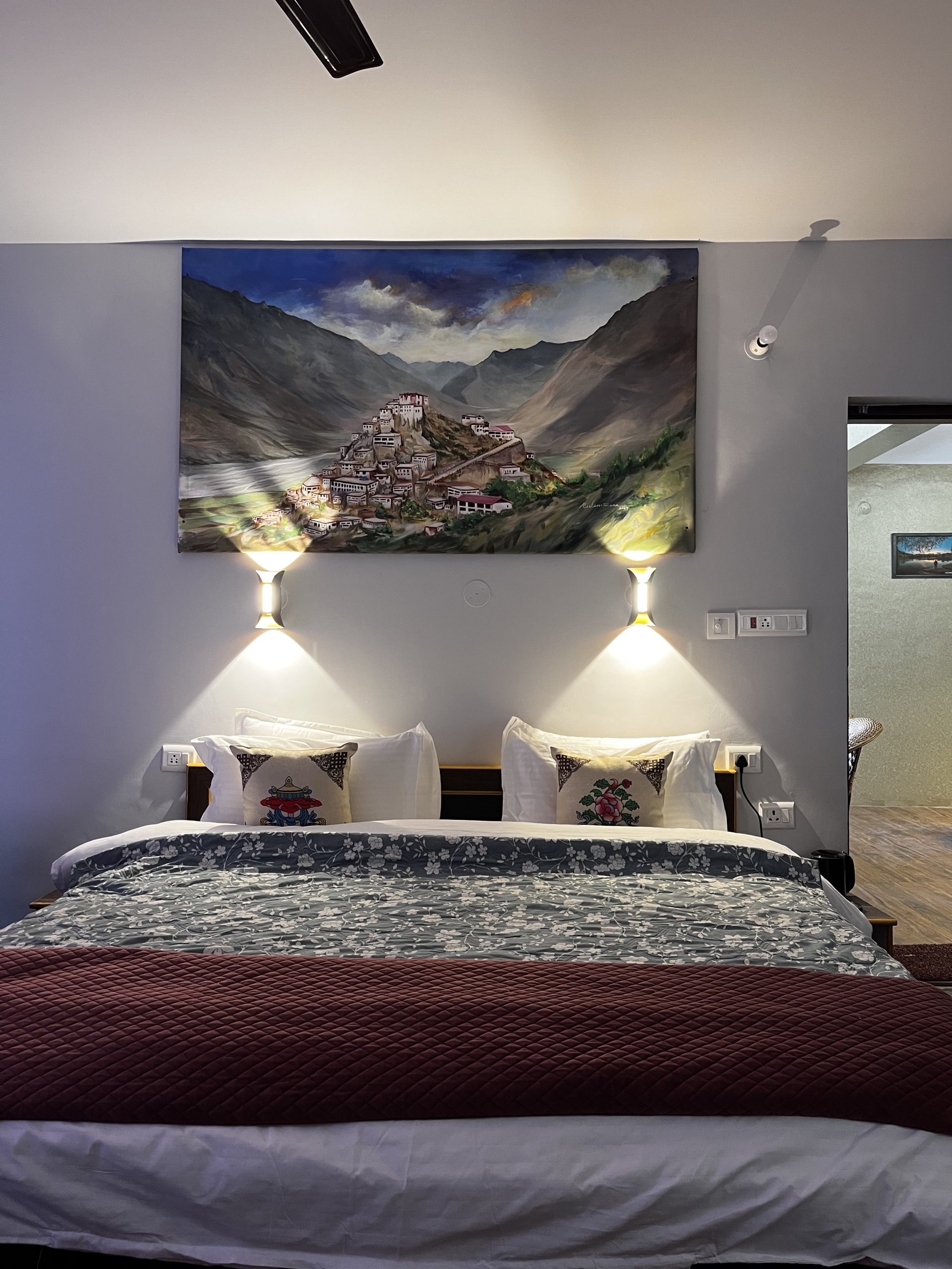 Cozy and warm room interior at White Lotus Homes in Tabo, featuring traditional wooden architecture and a scenic mountai
