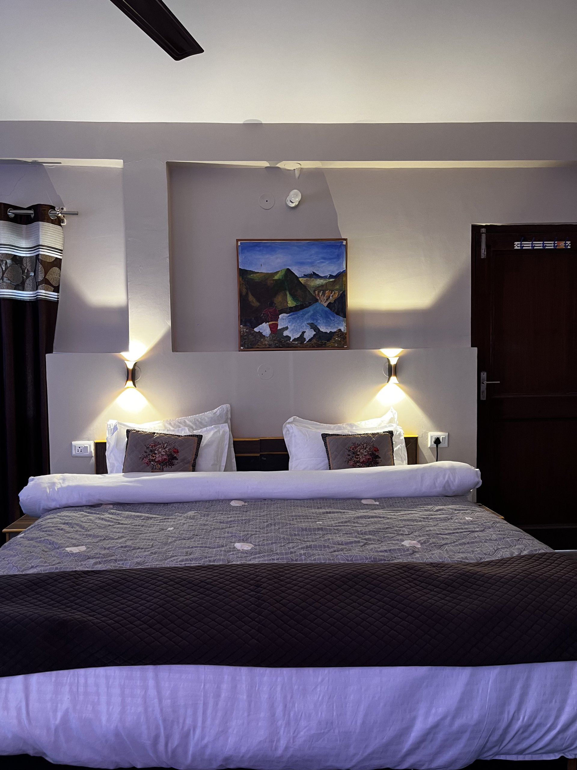 Cozy and warm room interior at White Lotus Homes in Tabo, featuring traditional wooden architecture and a scenic mountai
