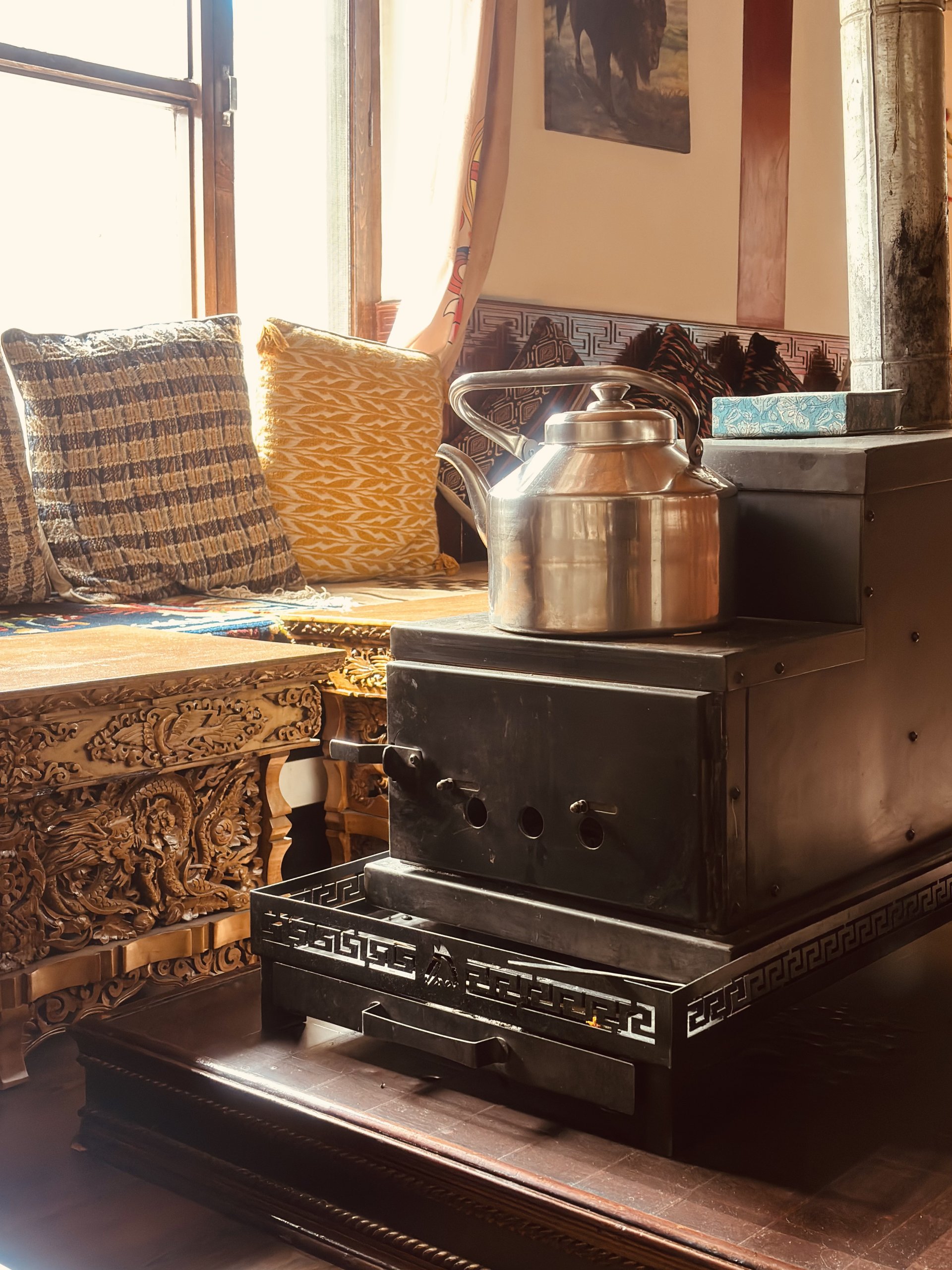 Cozy indoor tandoor and traditional heating setup at White Lotus Homes in Tabo, offering warmth during chilly Himalayan